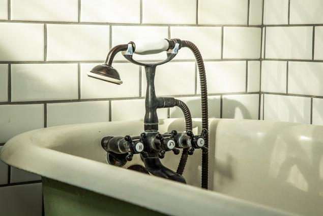 White subway tile with contrasting grout near bath tub